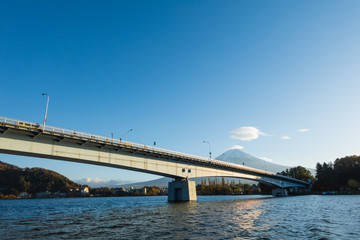 Mount Fuji view with a bridge across the lake Kawaguchiko from Yamanashi Prefecture, Japan.