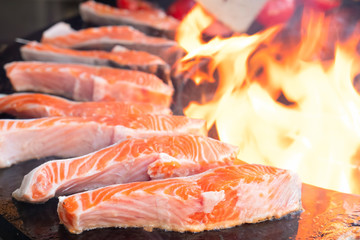 Salmon steaks on a grill. Bbq salmon on open flame. Picnic time. Outdoor