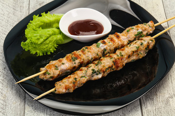 Minced pork skewer kebab with sauce