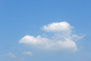 Clear blue sky background with white clouds