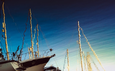 Abstract marine background with reflexions from the sailboats in harbour. Bright reflections of the...