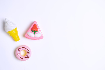 Collection of food toys for kids. Ice cream, slice of cake, donuts. Flay lay image. White background
