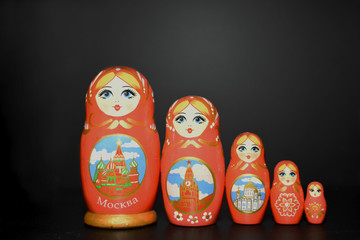 five russian dolls on a black background