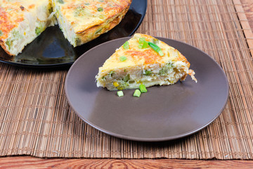 Portion of vegetable casserole against the rest part of casserole