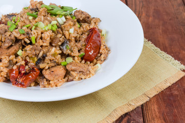 Paella with meat on dish on napkin close-up