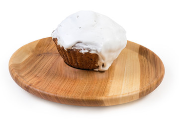 Cupcake covered with whipped egg whites icing on serving dish