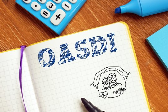Financial concept about Old-Age, Survivors, and Disability Insurance OASDI with inscription on the piece of paper.