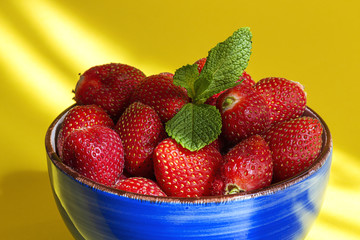 Healthy and fresh strawberries in bowl with mint