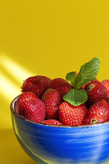 Healthy and fresh strawberries in bowl with mint