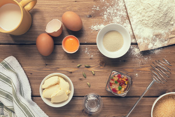 Basic ingredients for cooking Italian Christmas cake panettone on a wooden table