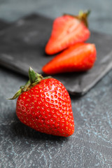 Sweet ripe strawberry on grey background