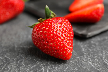 Sweet ripe strawberry on grey background