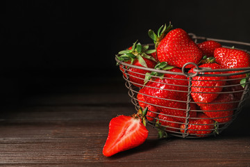 Basket with ripe strawberry on dark background