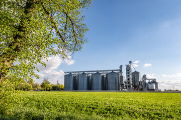Granary elevator on agro-processing and manufacturing plant for processing and silver silos for drying cleaning and storage of agricultural products, flour, cereals and grain. © hiv360