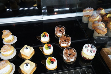 Assorted cake pastry and desserts displayed in  case box