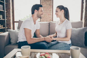 Photo of charming lady handsome guy couple relaxing sit comfy couch look eyes stay home good mood quarantine hold arms chatting listen love words spend time together living room indoors