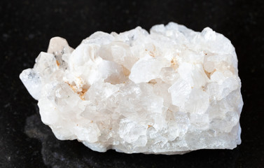 closeup of sample of natural mineral from geological collection - unpolished druse of colorless...