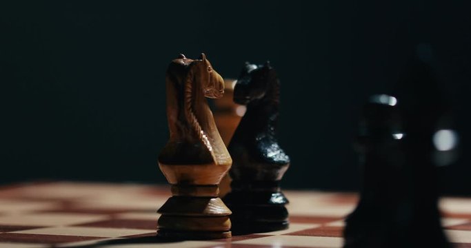  Two Chess knight and other figures spread on the chess board 4K video
