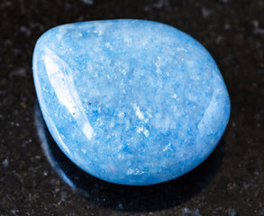 closeup of sample of natural mineral from geological collection - polished blue Aventurine gem...