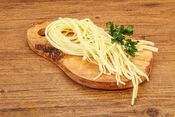 Chechil spaghetti cheese over board