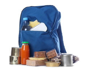 Schoolbag with different products on white background. Concept of Backpack Food Program