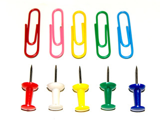 Push pins and paper clips in different colors isolated on white background.
