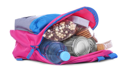 Schoolbag with different products on white background. Concept of Backpack Food Program