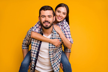 Naklejka premium Portrait of positive cheerful married couple man carry piggyback woman enjoy summer rest relax wear checkered plaid shirt isolated over bright shine color background