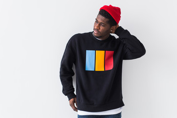 Street fashion concept - Studio shot of young handsome African man wearing sweatshirt against white background.