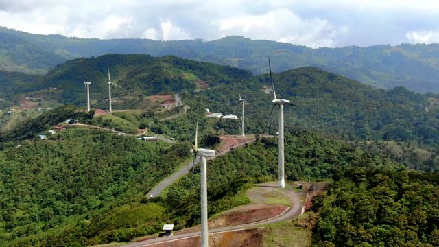Beautiful cinematic aerial view of the eolian renewable energy wind mild towers in Costa Rica