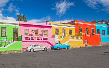 South Africa - Cape Town - The colorful multicolored houses, cottages and cars on steep street in...