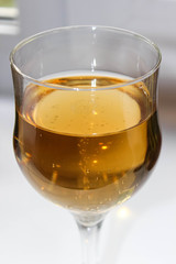 Yellow transparent drink wine or juice in a glass glass.