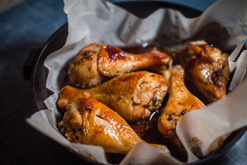 Cooked in oven chicken legs wit crispy crust. Dishes cooked at home. Chicken cooked according to simple recipes.