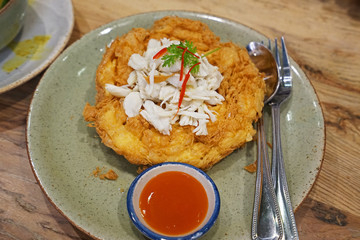 Deep fried crab meat omelet served with chili sauce