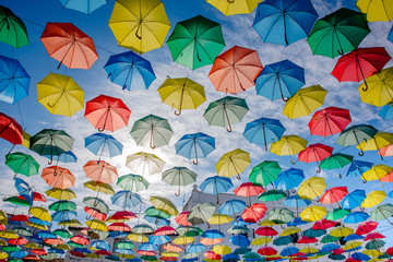 Fototapeta na wymiar Umbrellas floating in the sky with lots of color