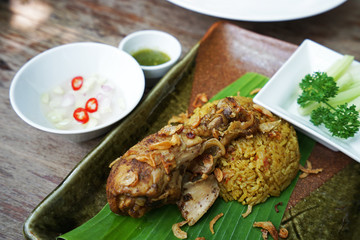 Muslim yellow rice served with chicken and soup
