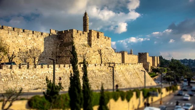 Time lapse of the Tower of David museum and the Ottoman-built fortified walls of the Old City, with clouds moving and the road leading upto Jaffa Gate; Jerusalem Israel