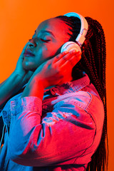 Lifestyle concept - Portrait of beautiful African American woman joyful listening to music.