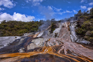 Charm of colored Orakei Korako with clouds in the blue sky. North Island of New Zealand