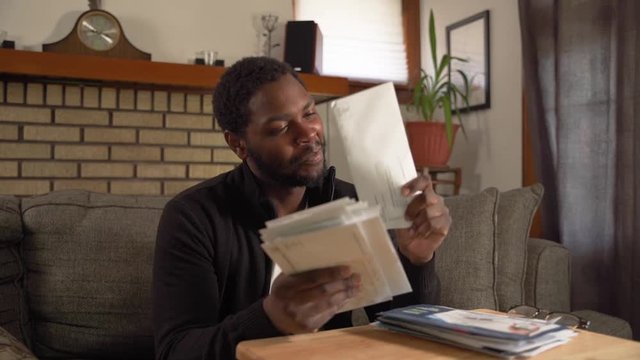 Black man receiving important mail excited close up