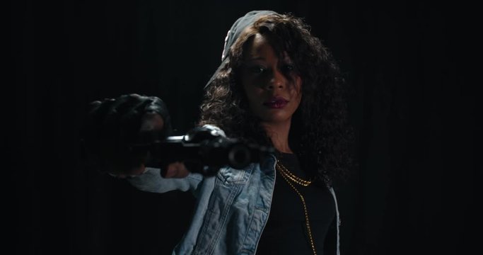 Criminal woman is pointing a gun at the camera, dangerous lady, 4k