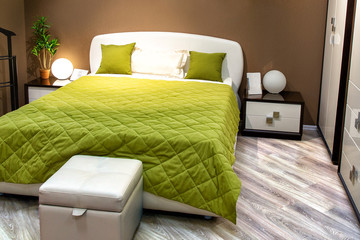 Interior of modern cozy bedroom. Double bed and table lamps