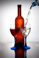 Water is poured into glass glasses standing on glass