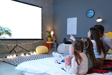 Young family watching movie at home