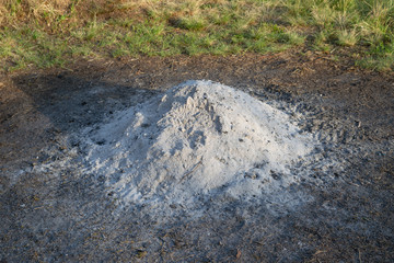 Gray white ash ashes pile heap stack from burnt campfire lumber fire