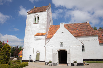 Fototapeta na wymiar old danish church with blue sky and clouds