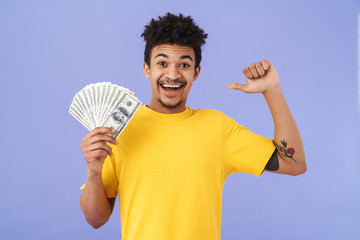 Photo of african american man holding dollars and pointing thumb himself