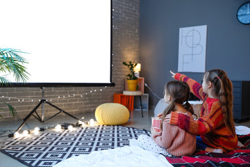 Little girls watching movie at home