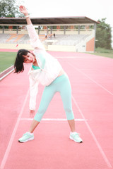 Young runner men stretching body before exercise run outdoor on athletic track, jogger athlete training workout outdoor, sport woman doing exercise at track and field stadium