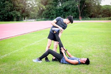 Fototapeta na wymiar Partner buddy runner men help each other stretching body before exercise run outdoor, jogger athlete training and doing workout on green grass lawn